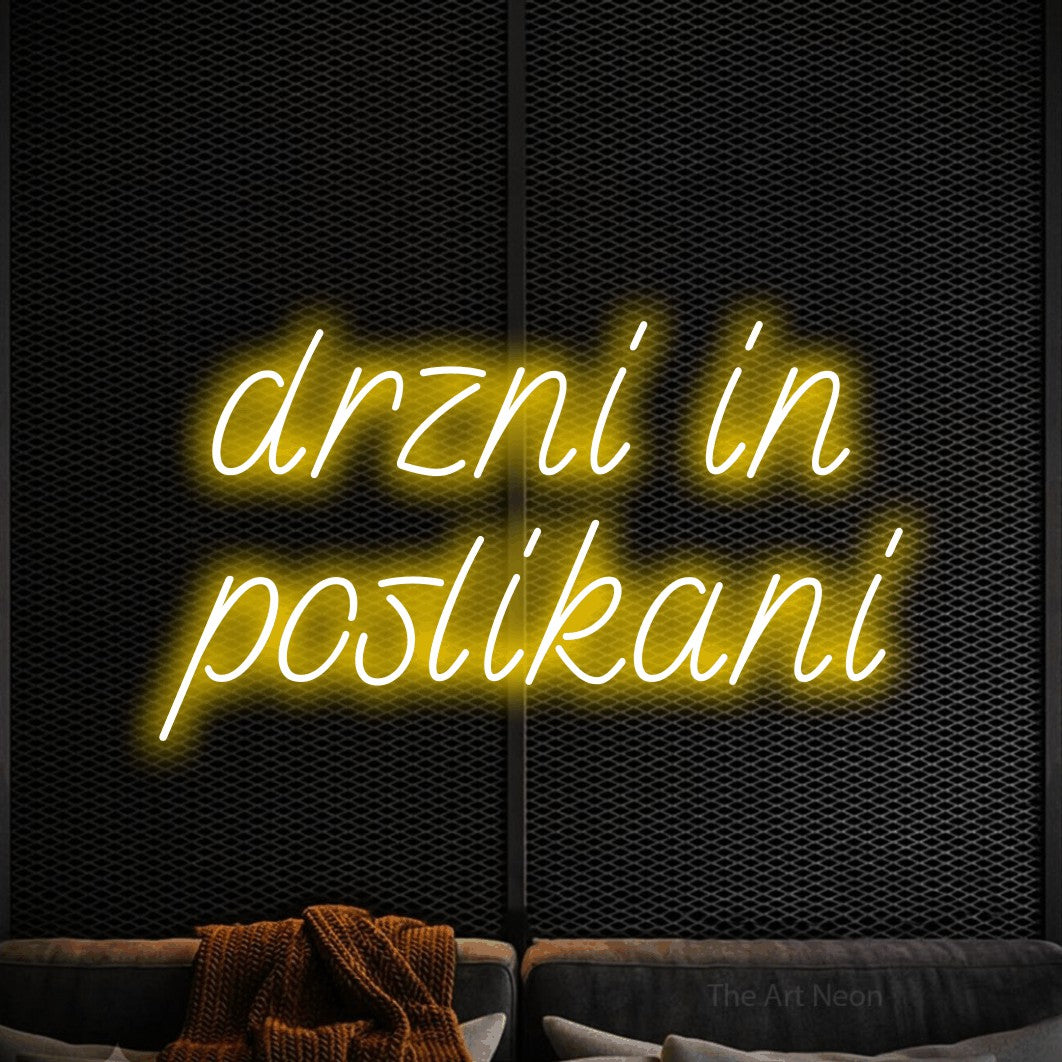 LED neon sign reading “drzni in poslikani”, arranged in two lines.