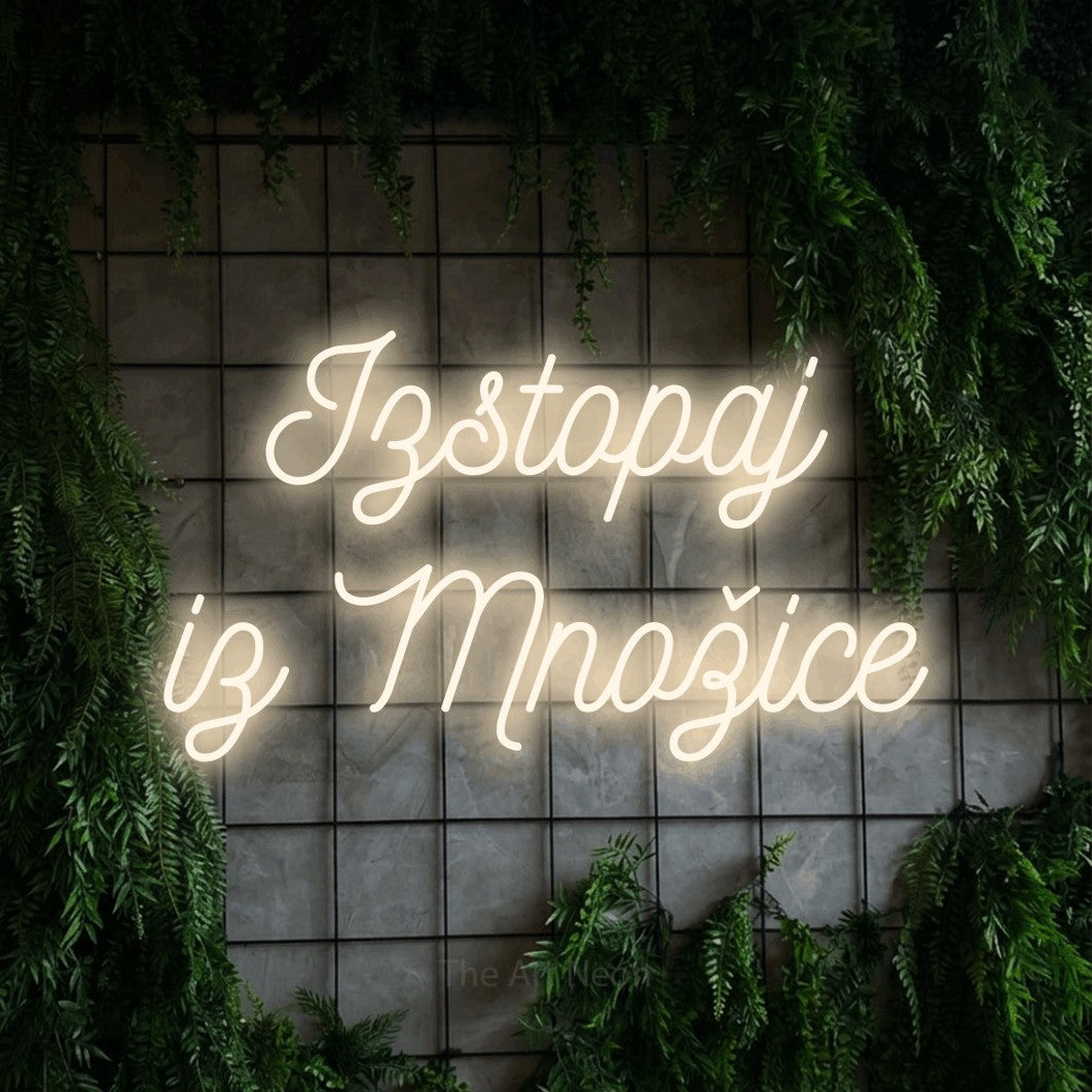LED neon sign reading “Izstopaj iz Množice”, arranged in two lines.