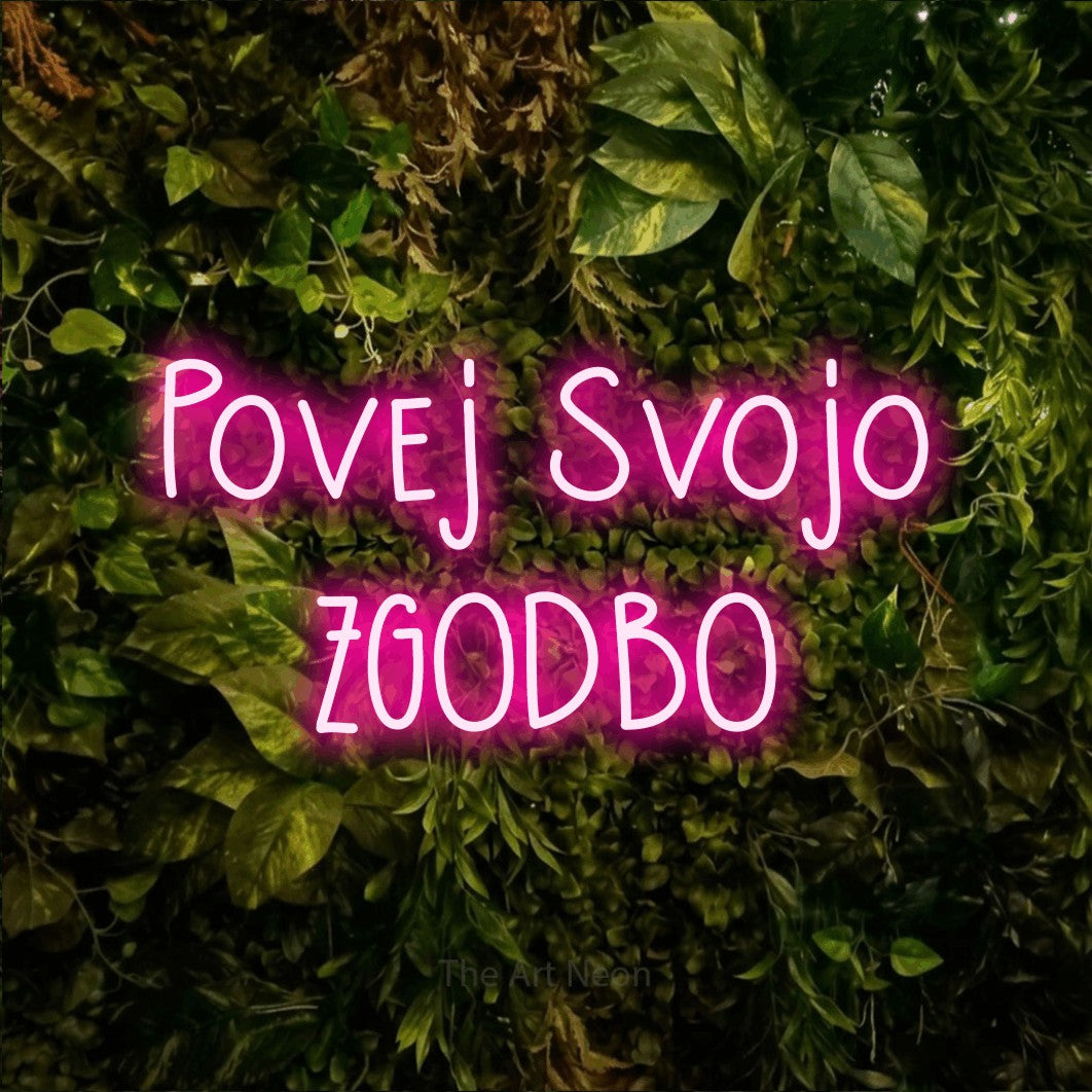 LED neon sign reading “Povej Svojo ZGODBO”, arranged in two lines.