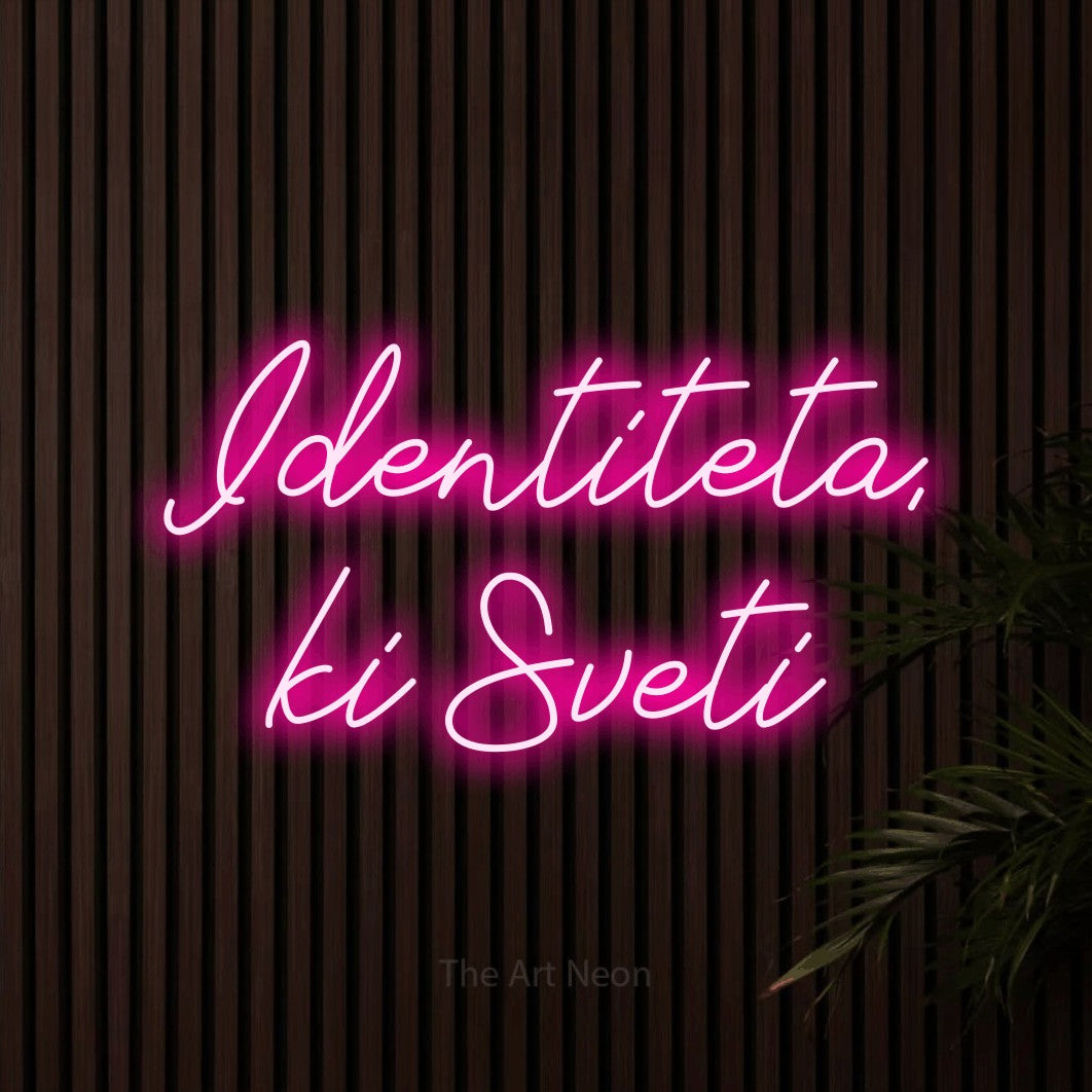 LED neon sign reading “Identiteta, ki Sveti”, arranged in two lines.