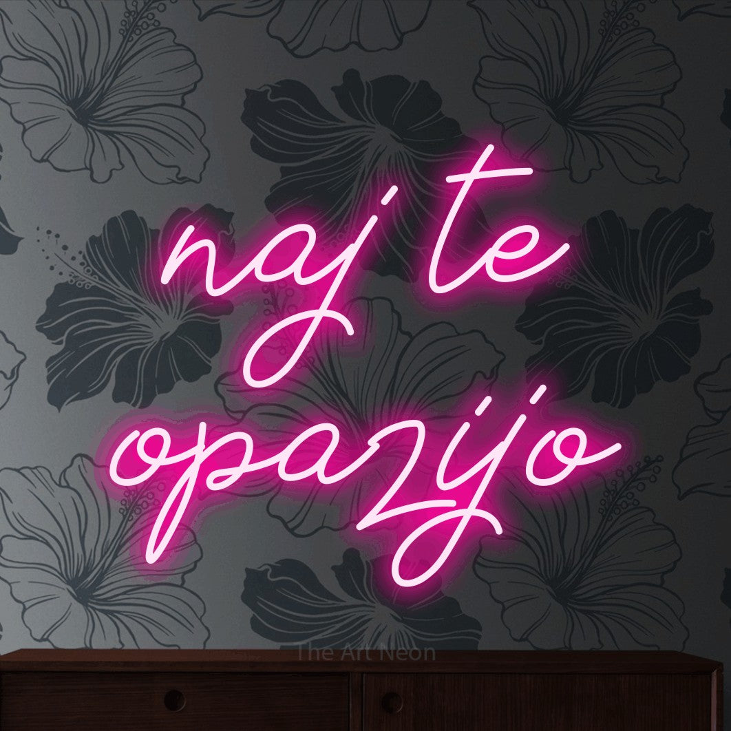 LED neon sign reading “naj te opazijo”, arranged in two lines.