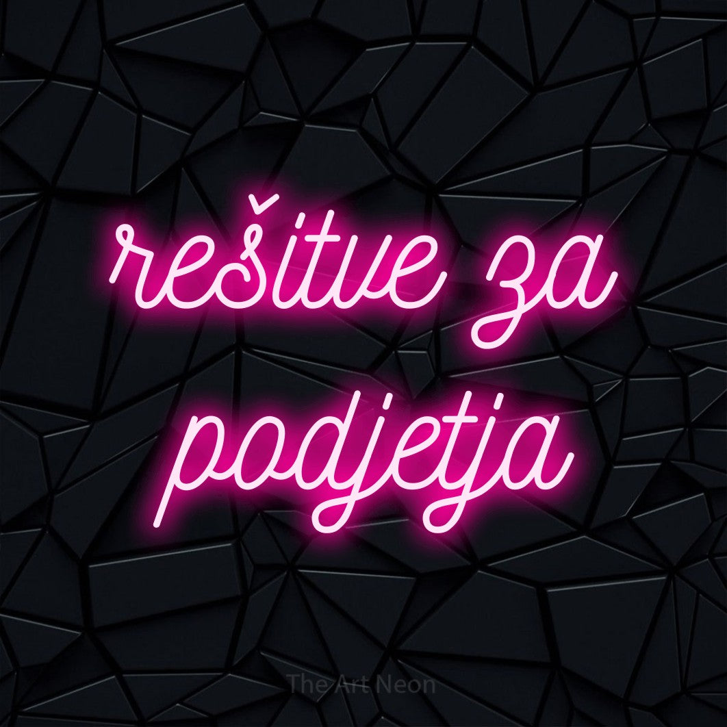 LED neon sign reading “rešitve za podjetja”, arranged in two lines.
