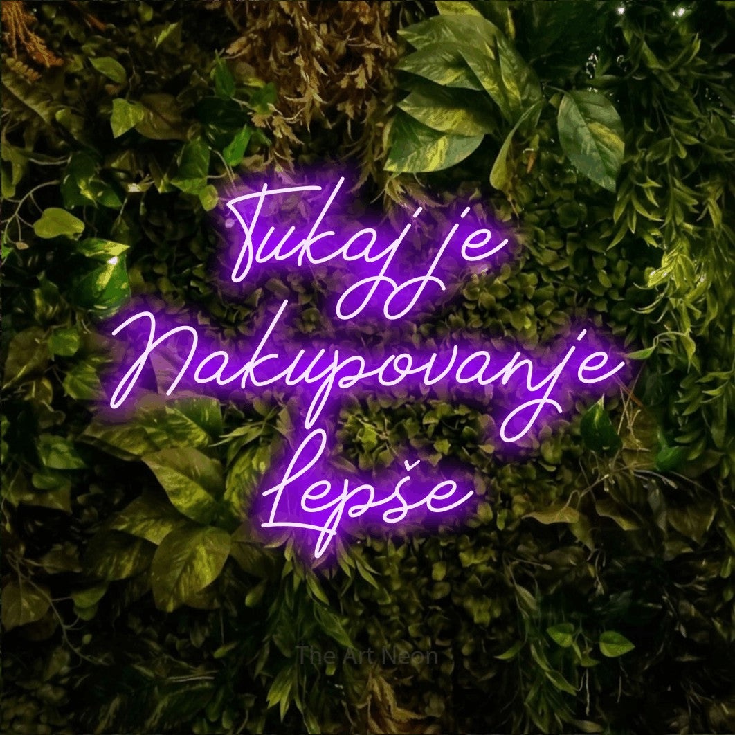 LED neon sign reading “Tukaj je Nakupovanje Lepše”, arranged in three lines.