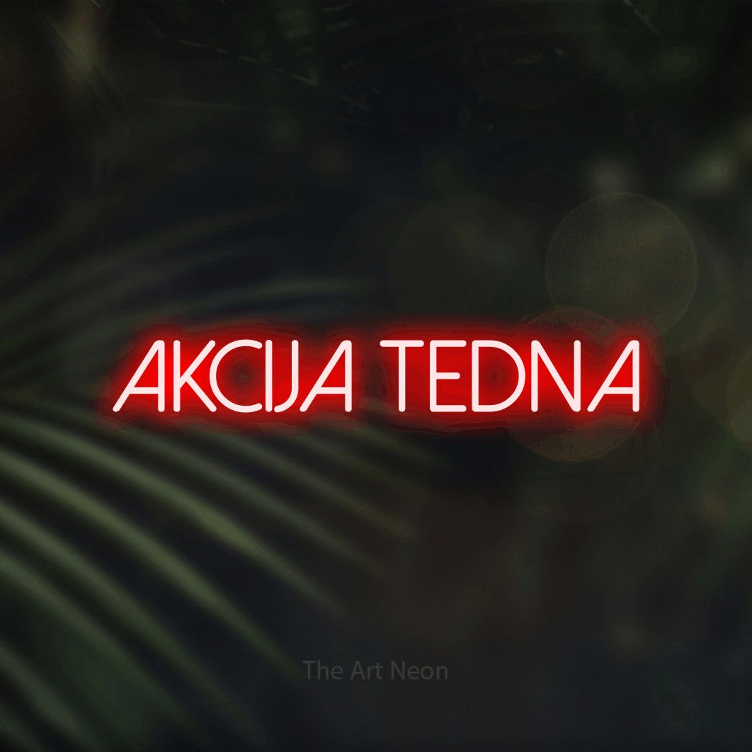 LED neon sign reading “akcija tedna”, arranged in a single line.