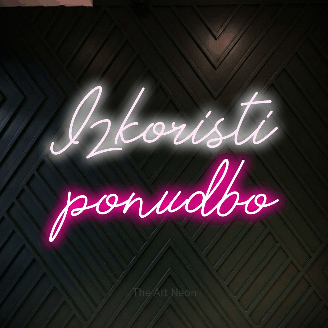LED neon sign reading “Izkoristi ponudbo”, arranged in two lines.