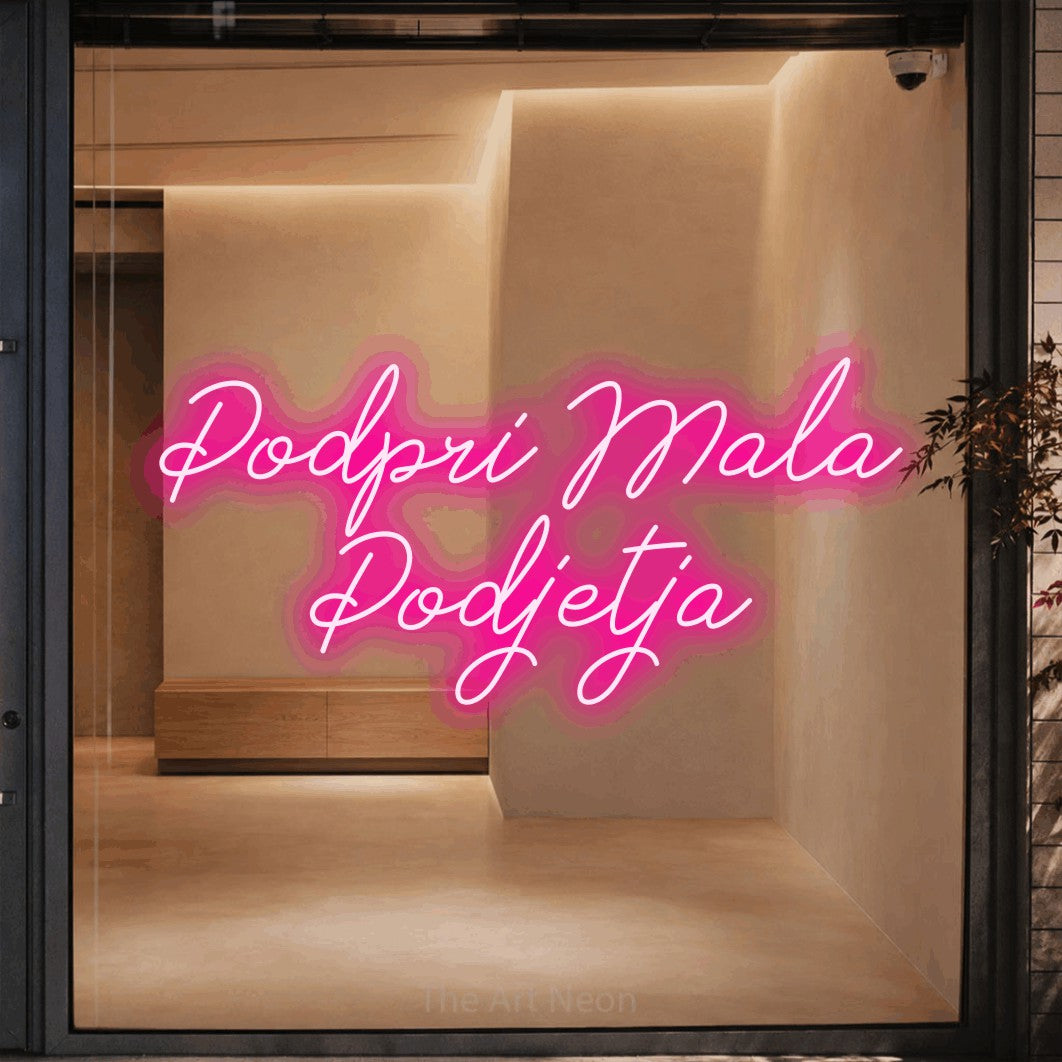 LED neon sign reading “Podpri Mala Podjetja”, arranged in two lines.