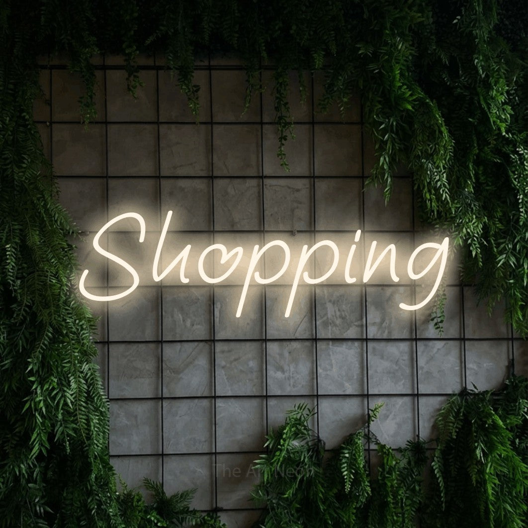 LED neon sign reading “Shopping”, arranged in a single line.