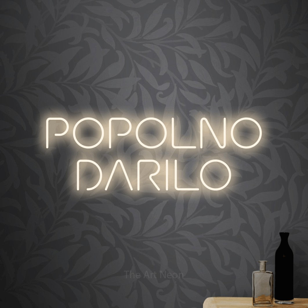 LED neon sign reading “POPOLNO DARILO”, arranged in two lines.