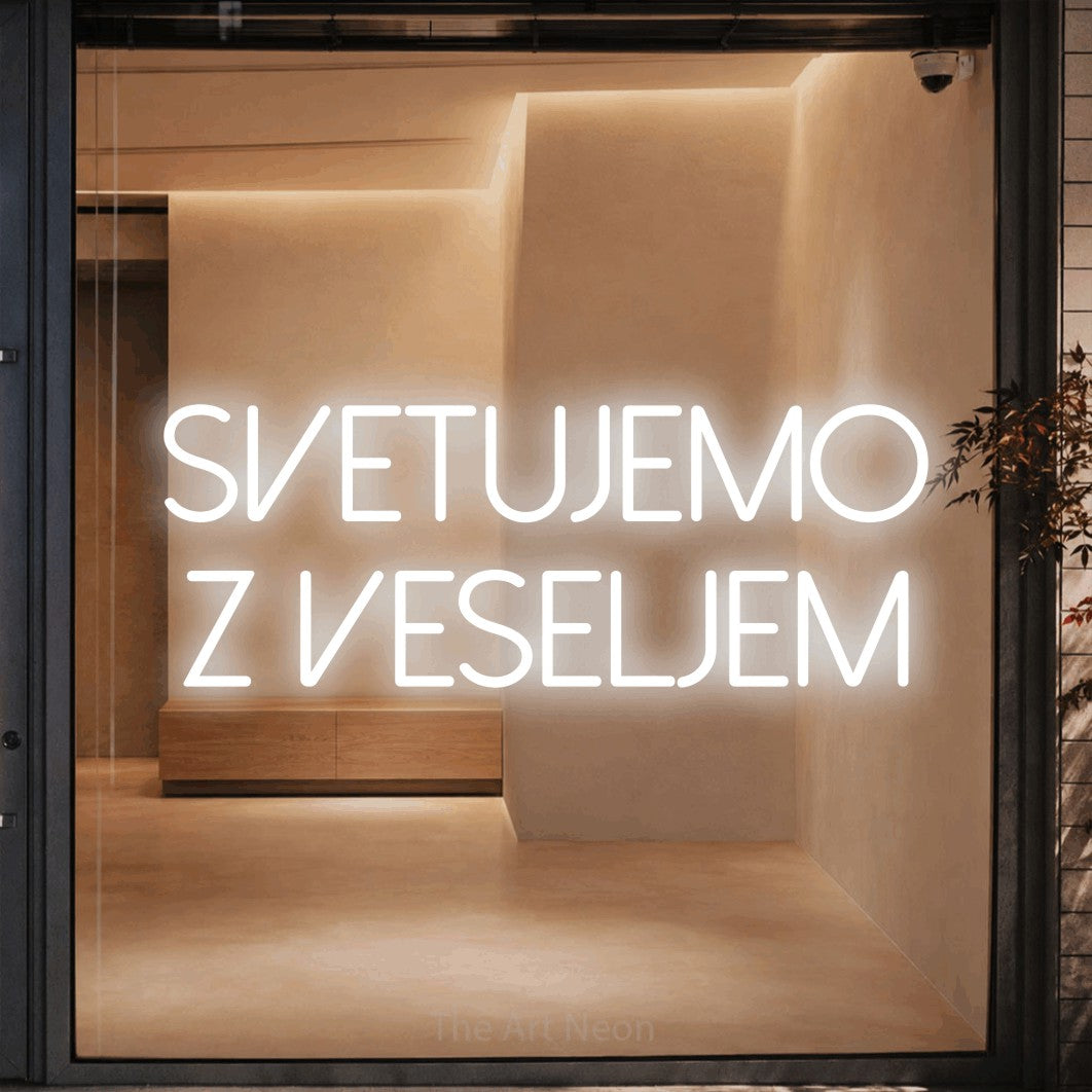 LED neon sign reading “svetujemo z veseljem”, arranged in two lines.