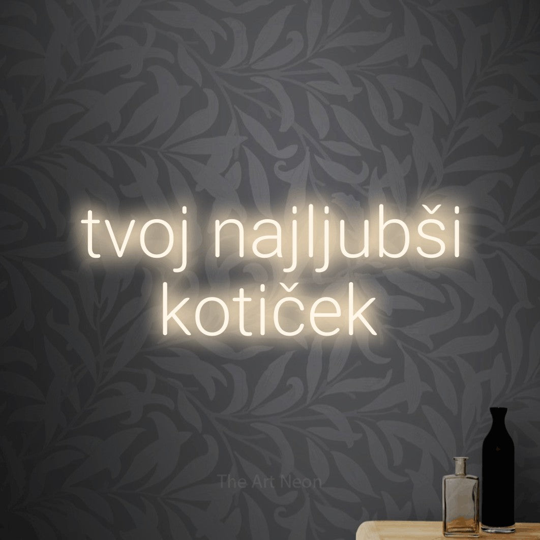LED neon sign reading “tvoj najljubši kotiček”, arranged in two lines.