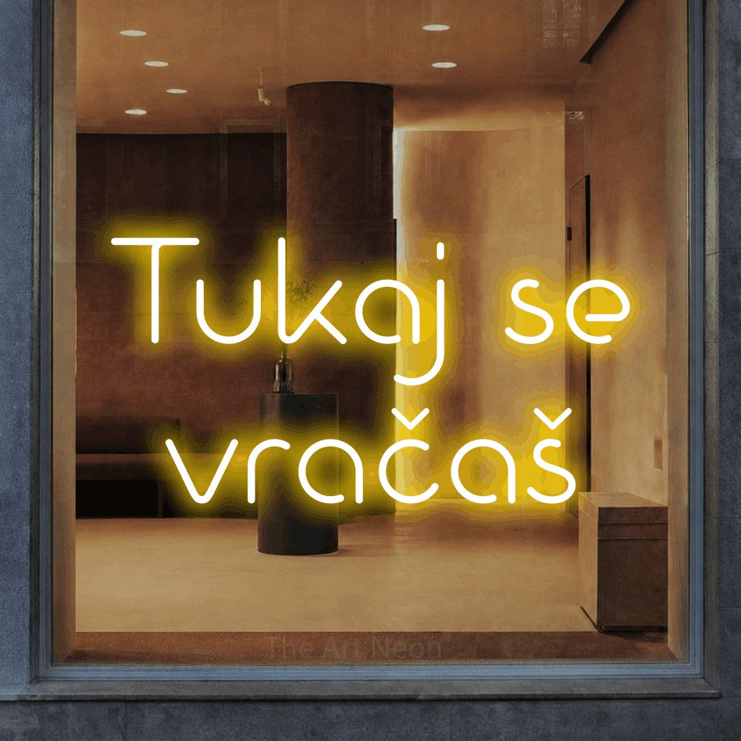 LED neon sign reading “Tukaj se vračaš”, arranged in two lines.