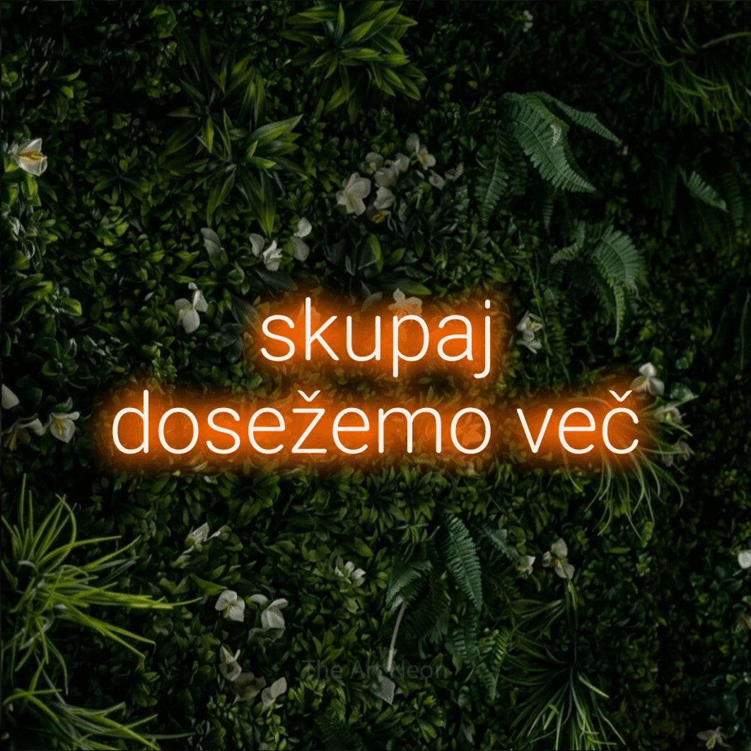 LED neon sign reading “skupaj dosežemo več”, arranged in two lines.