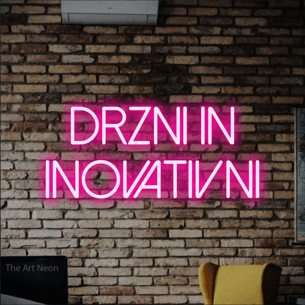 LED neon sign reading “Drzni in Inovativni”, arranged in two lines.