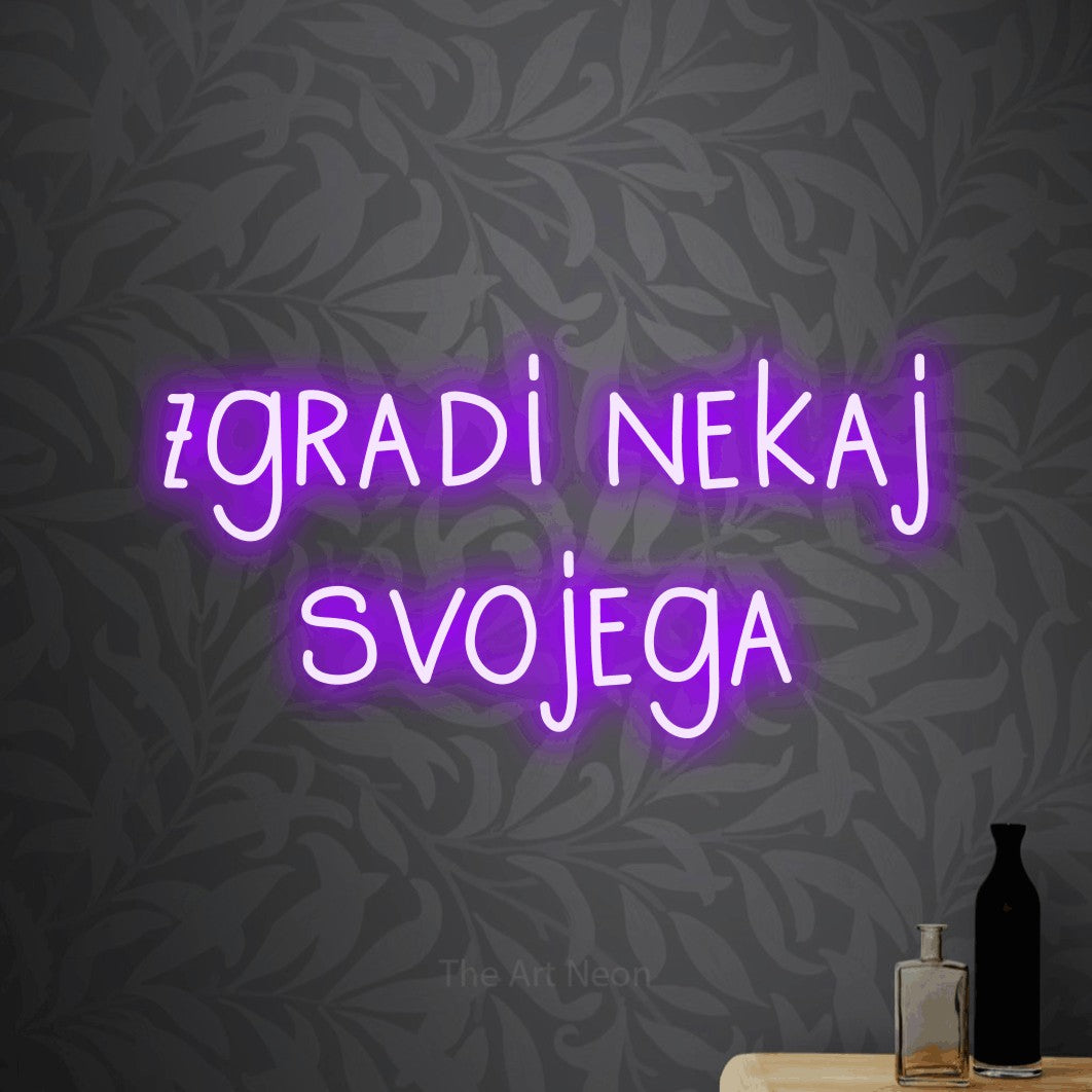 LED neon sign reading “zgradi nekaj svojega”, arranged in two lines.
