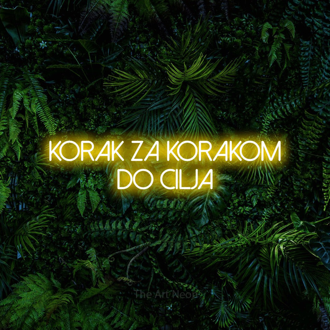 LED neon sign reading “Korak za Korakom do Cilja”, arranged in two lines.