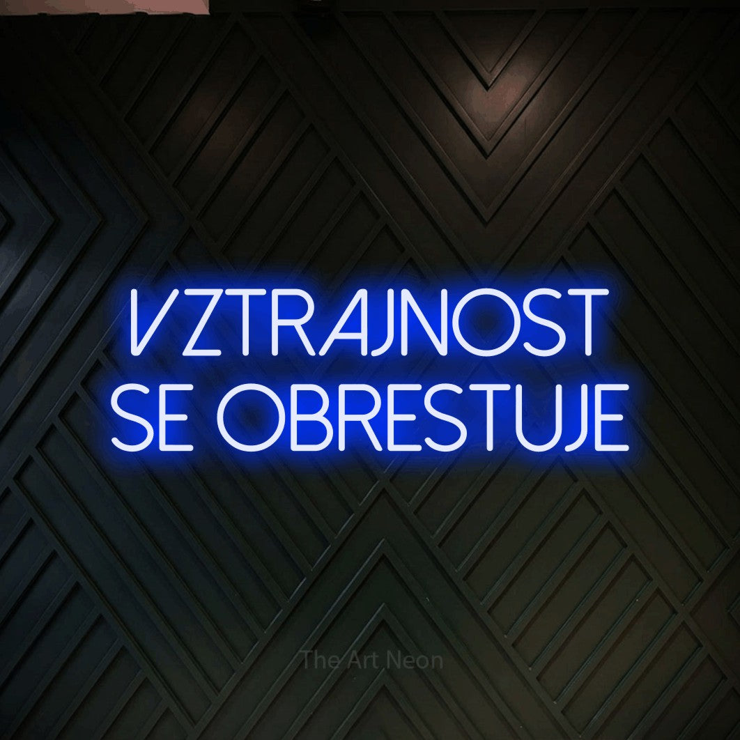 LED neon sign reading “VZTRAJNOST se Obrestuje”, arranged in two lines.