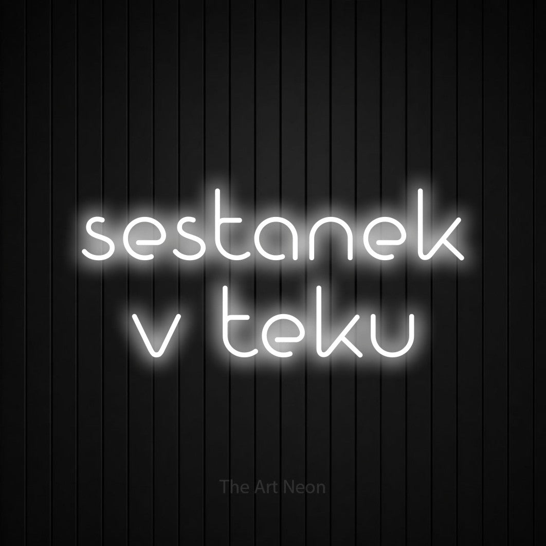 LED neon sign reading “sestanek v teku”, arranged in two lines.