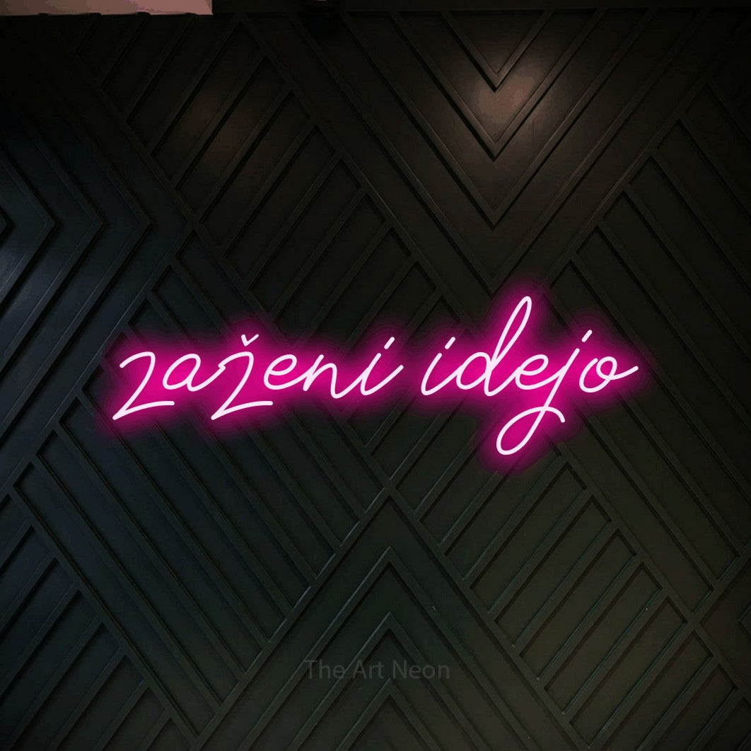LED neon sign reading “zaženi idejo”, arranged in a single line.
