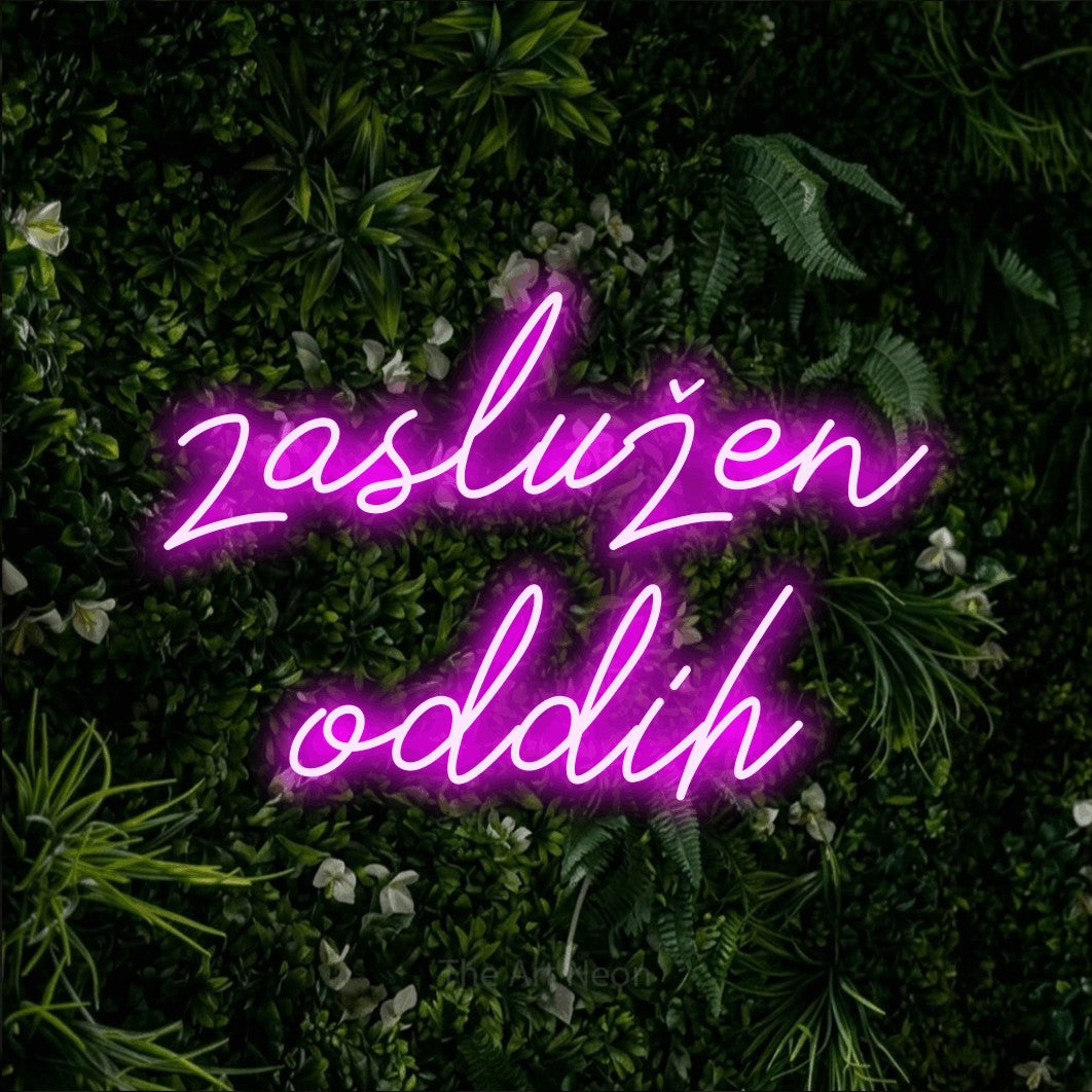 LED neon sign reading “zaslužen oddih”, arranged in two lines.