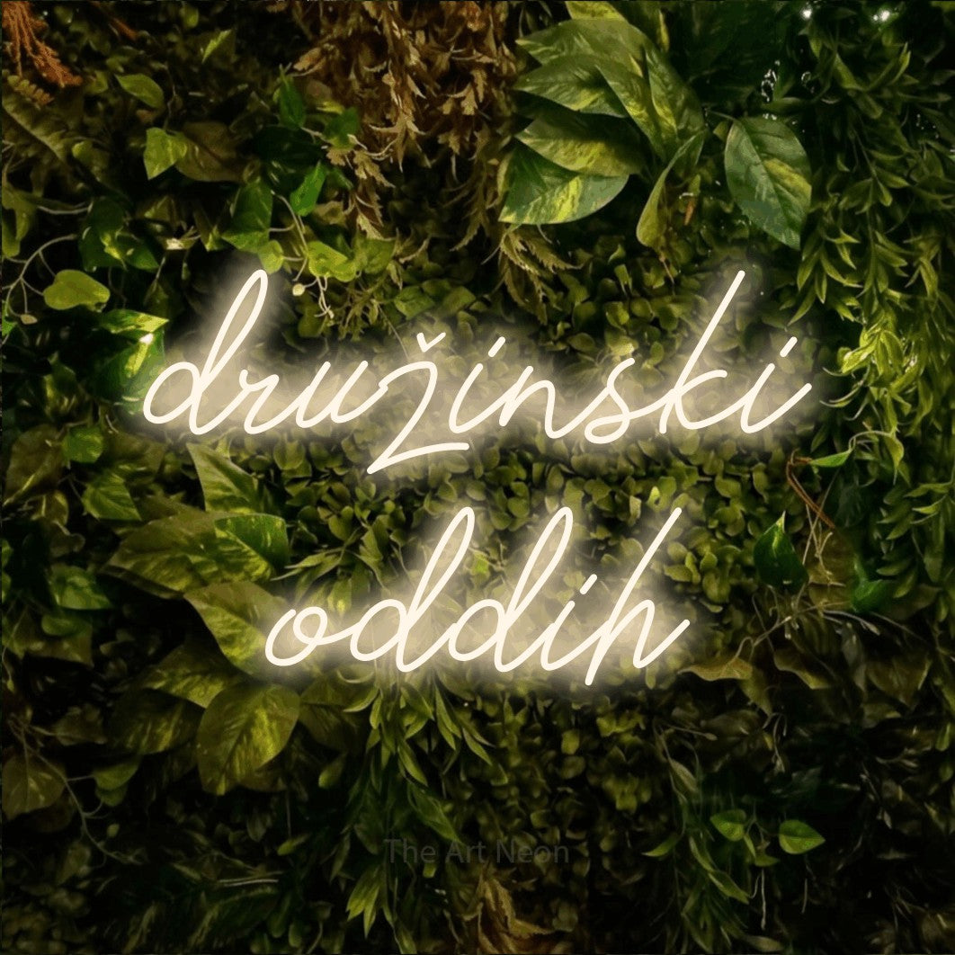 LED neon sign reading “družinski oddih”, arranged in two lines.