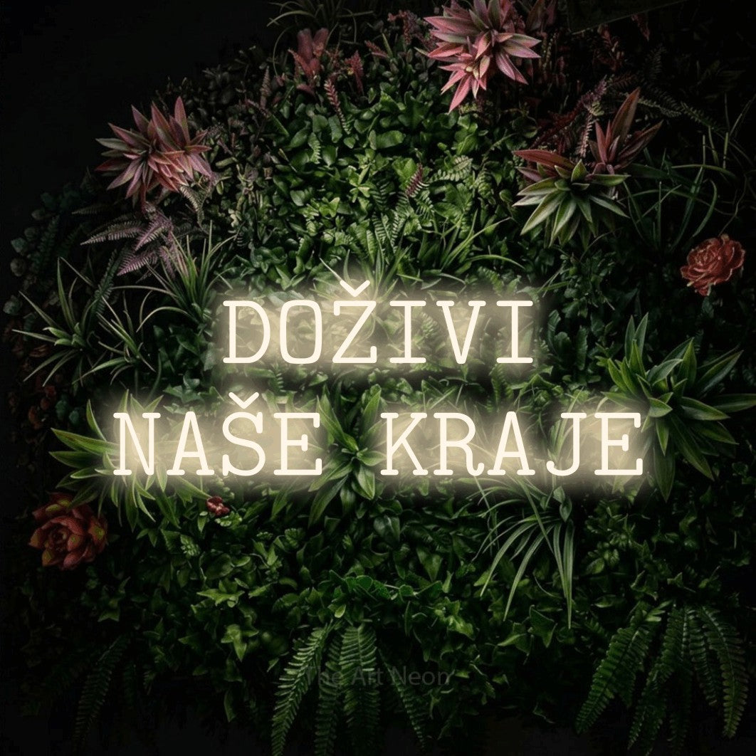 LED neon sign reading “DOŽIVI NAŠE KRAJE”, arranged in two lines.
