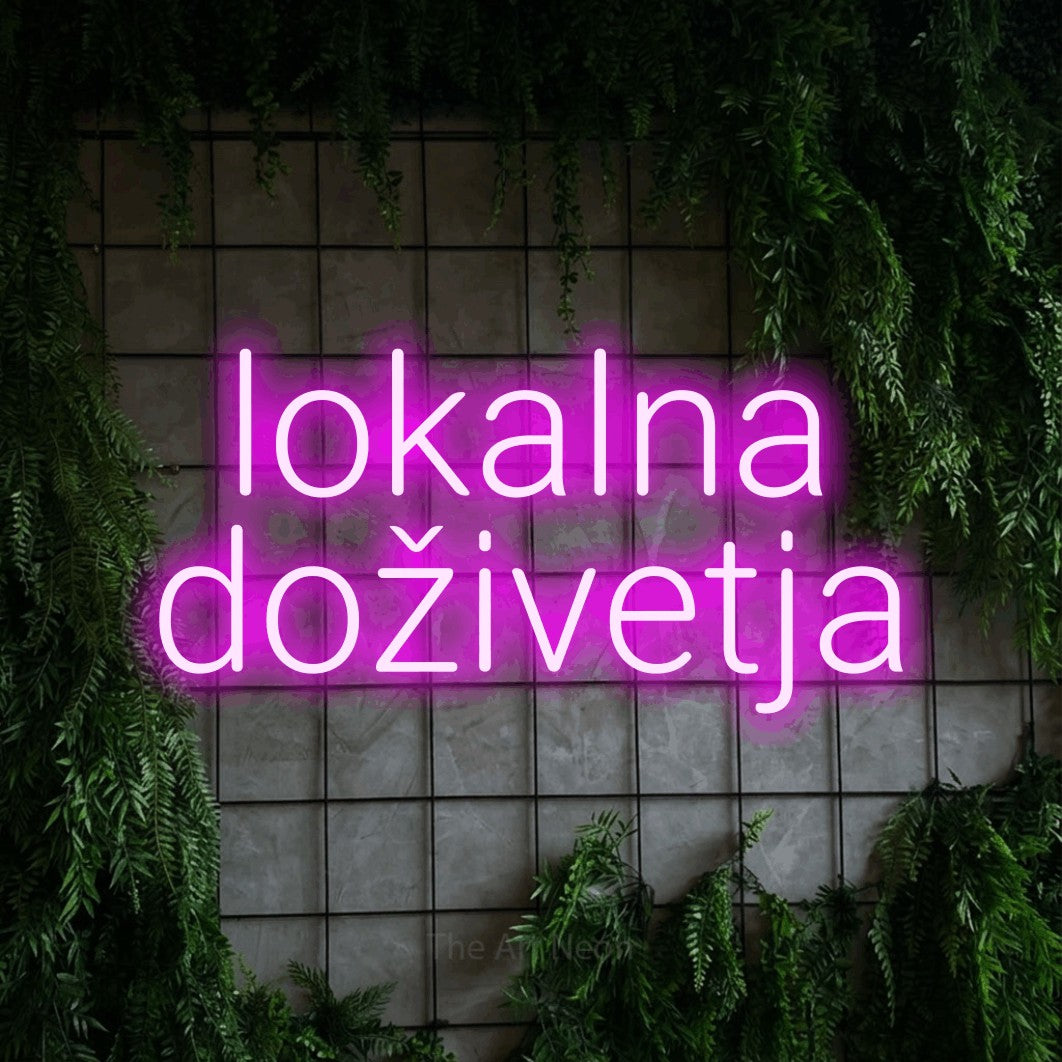 LED neon sign reading “lokalna doživetja”, arranged in two lines.