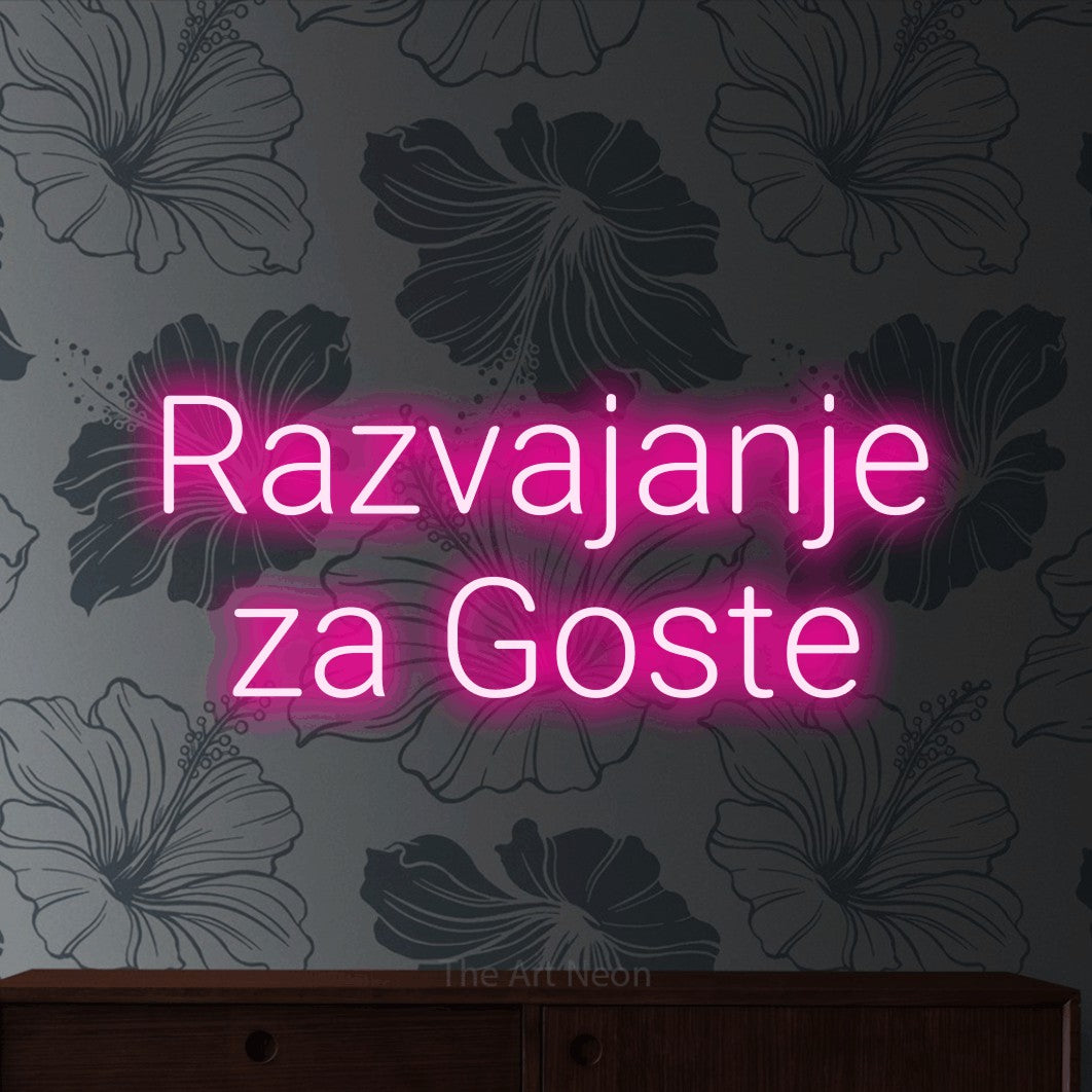 LED neon sign reading “Razvajanje za Goste”, arranged in two lines.