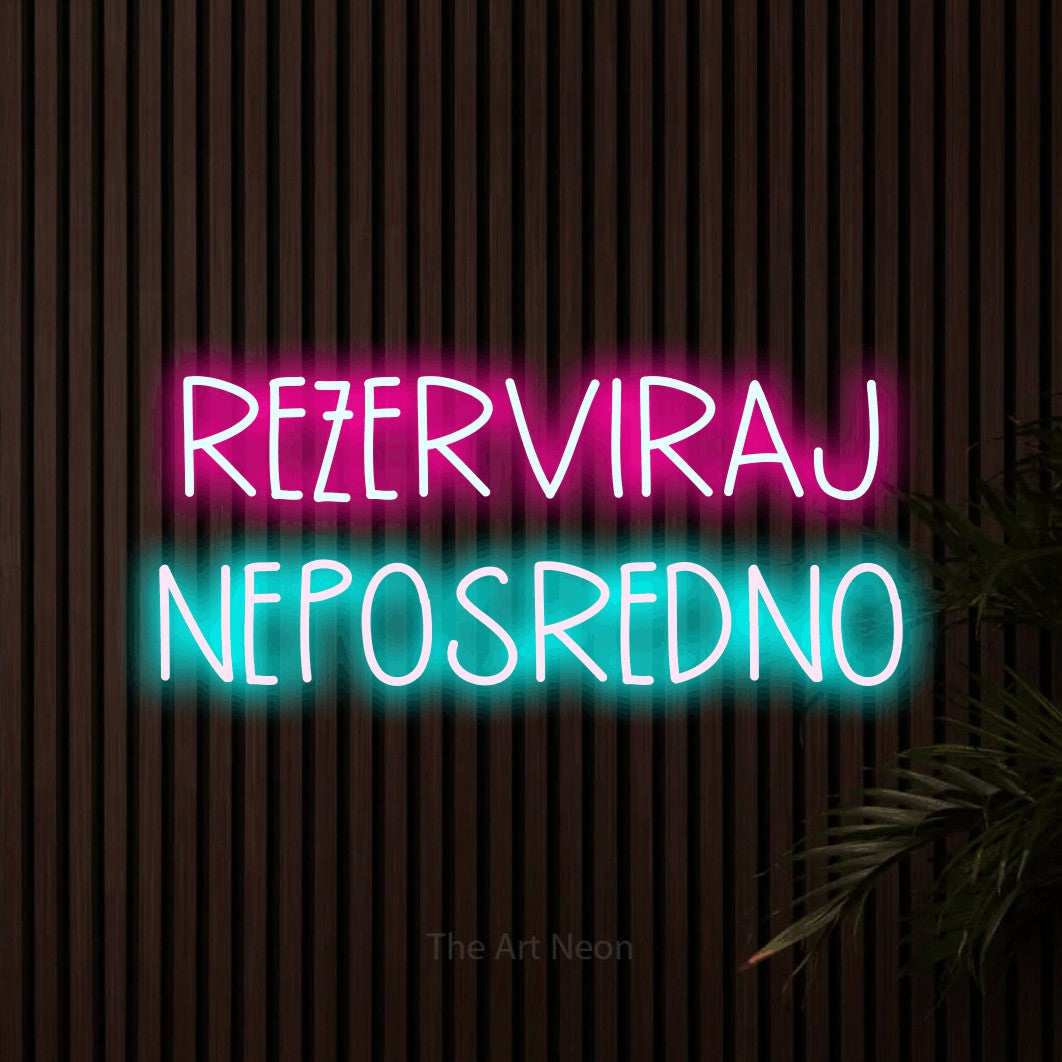 LED neon sign reading “REZERVIRAJ NEPOSREDNO”, arranged in two lines.