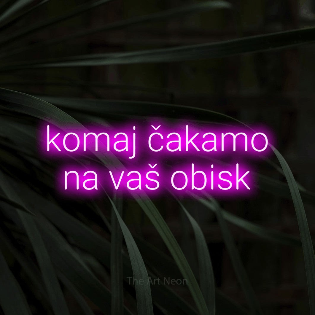 LED neon sign reading “komaj čakamo na vaš obisk”, arranged in two lines.