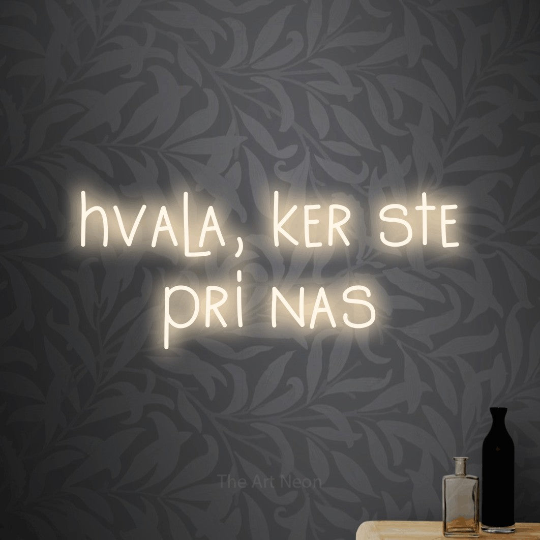 LED neon sign reading “hvala, ker ste pri nas”, arranged in two lines.