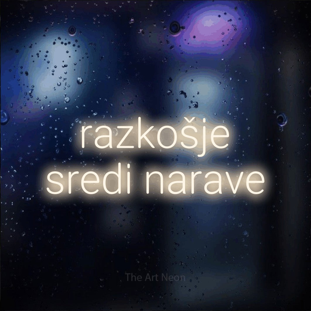 LED neon sign reading “razkošje sredi narave”, arranged in two lines.