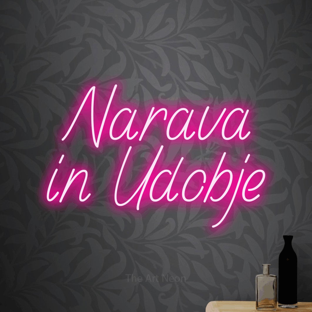 LED neon sign reading “Narava in Udobje”, arranged in two lines.