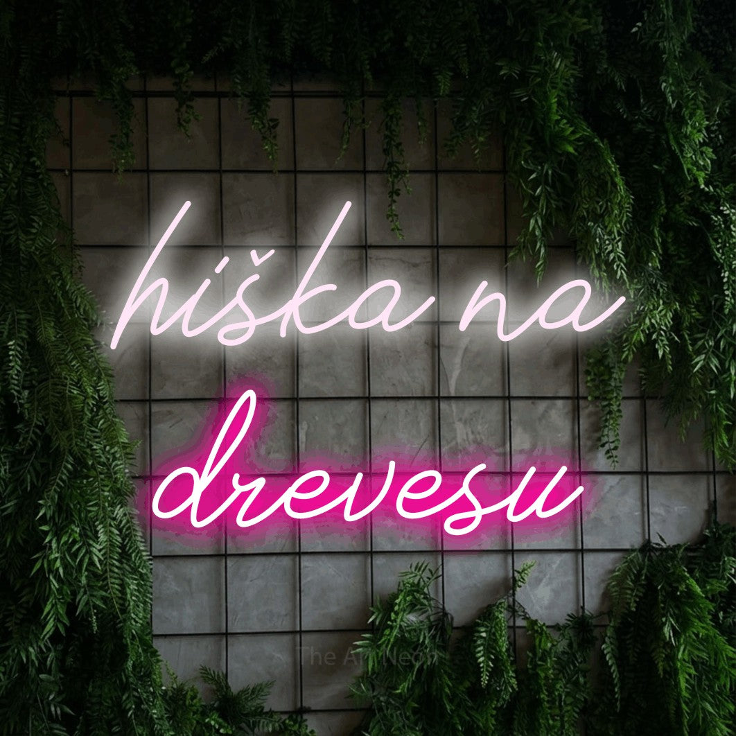LED neon sign reading “hiška na drevesu”, arranged in two lines.