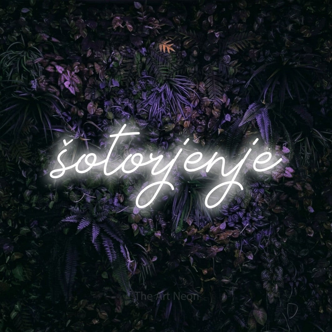 LED neon sign reading “šotorjenje”, arranged in a single line.