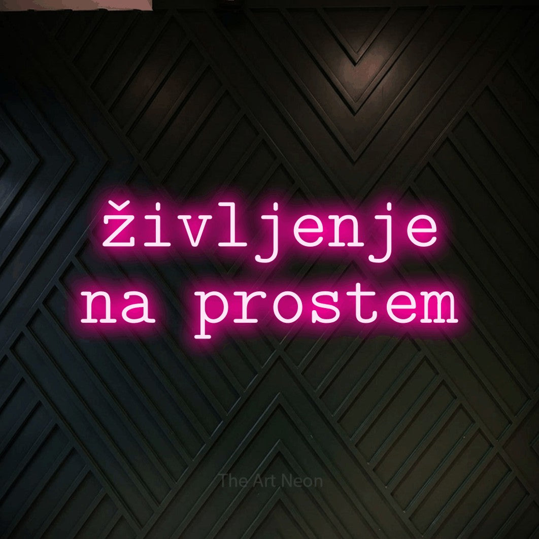 LED neon sign reading “življenje na prostem”, arranged in two lines.