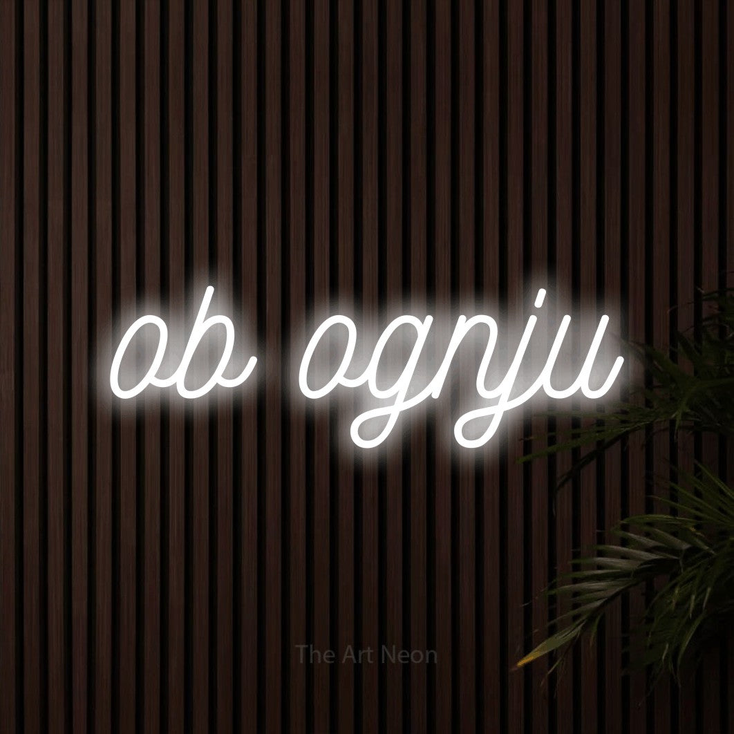 LED neon sign reading “ob ognju”, arranged in a single line.