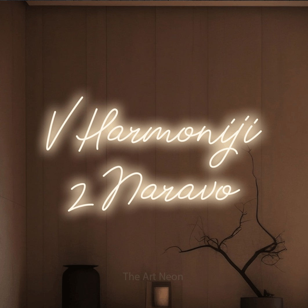 LED neon sign reading “V Harmoniji z Naravo”, arranged in two lines.