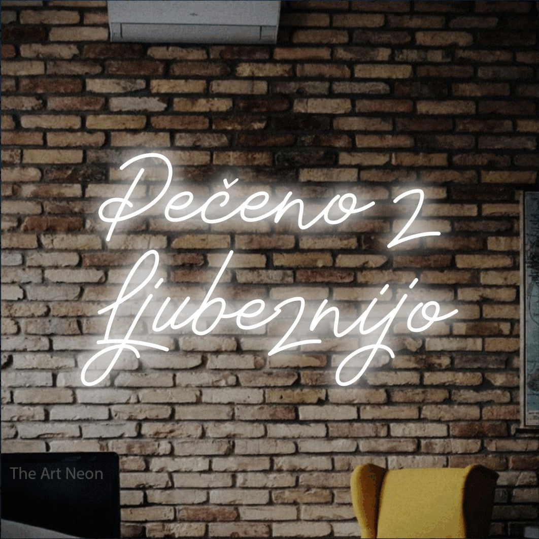 LED neon sign reading “Pečeno z Ljubeznijo”, arranged in two lines.