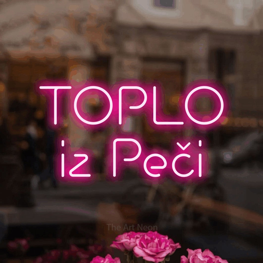 LED neon sign reading “TOPLO iz Peči”, arranged in two lines.