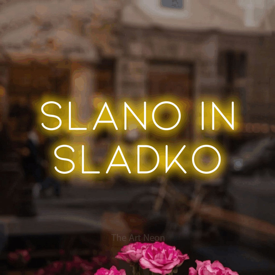 LED neon sign reading “SLANO IN SLADKO”, arranged in two lines.