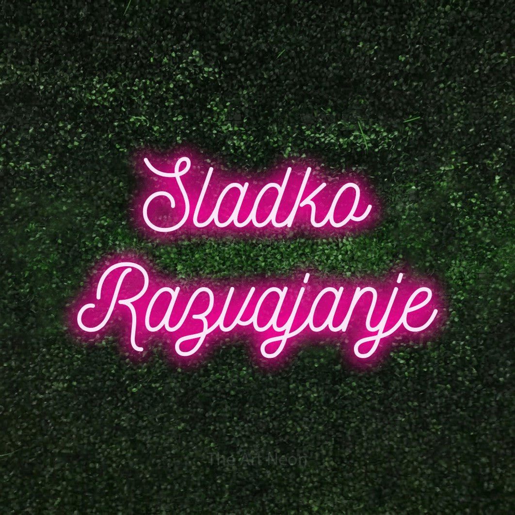 LED neon sign reading “Sladko Razvajanje”, arranged in two lines.