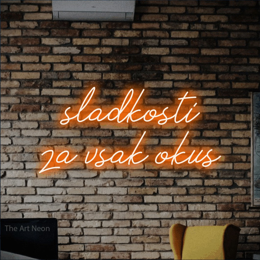LED neon sign reading “sladkosti za vsak okus”, arranged in two lines.