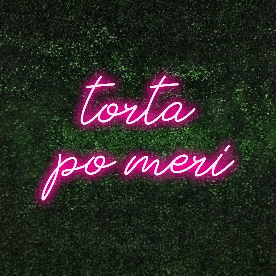 LED neon sign reading “torta po meri”, arranged in two lines.