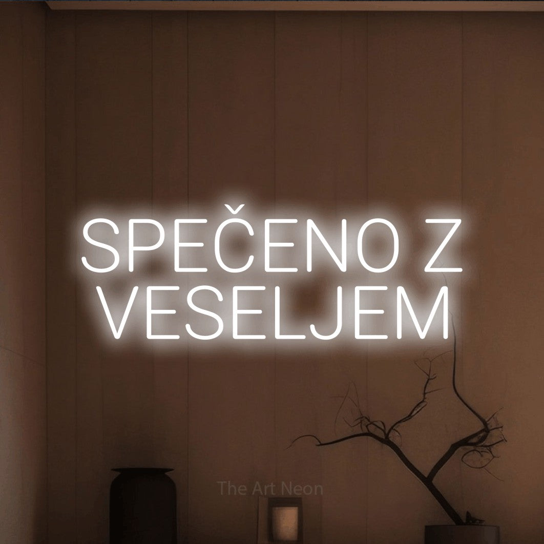 LED neon sign reading “SPEČENO Z VESELJEM”, arranged in two lines.