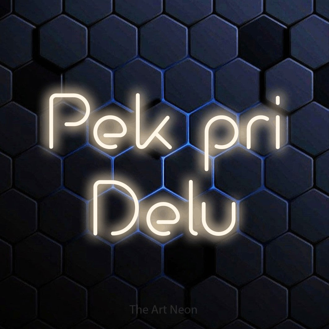 LED neon sign reading “Pek pri Delu”, arranged in two lines.