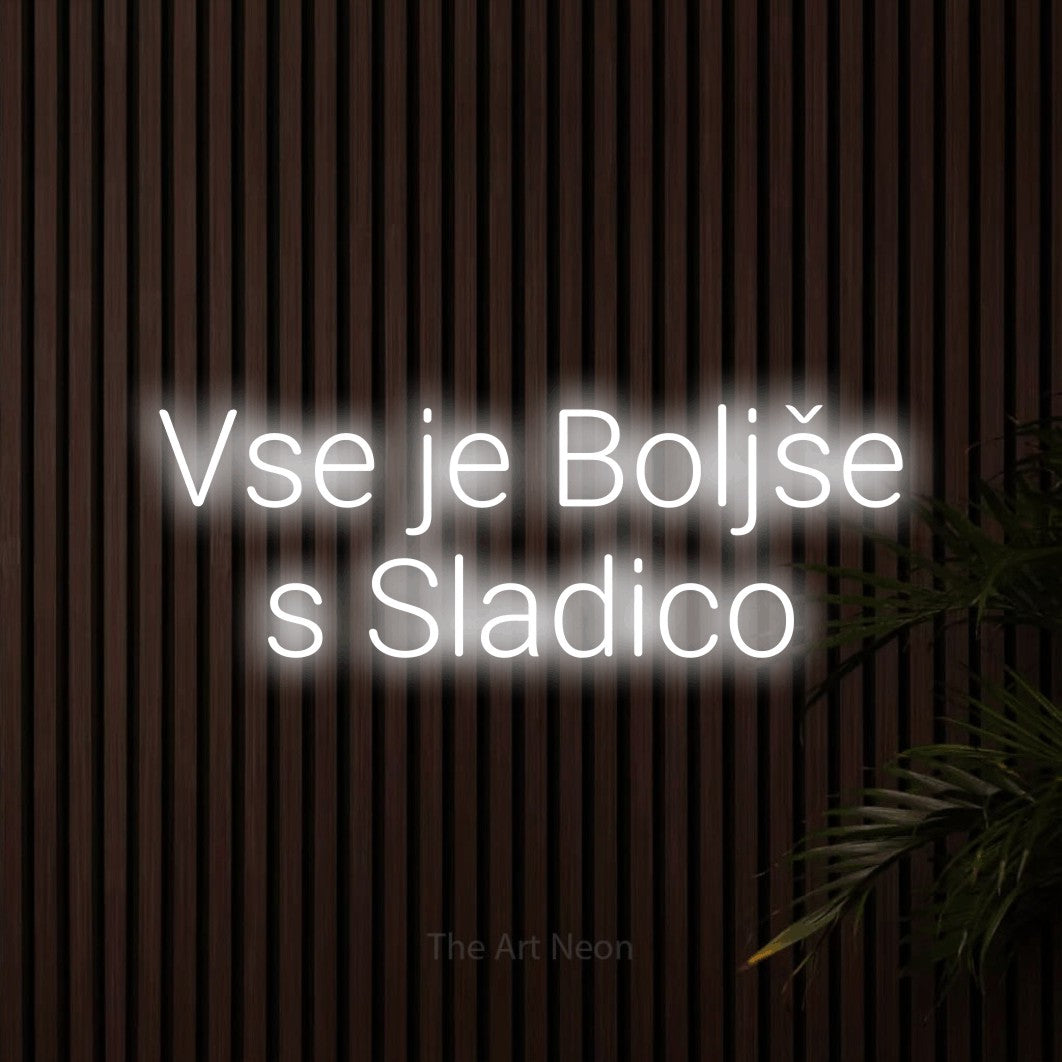 LED neon sign reading “Vse je Boljše s Sladico”, arranged in two lines.