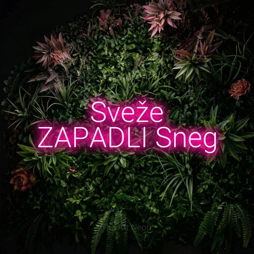 LED neon sign reading “Sveže ZAPADLI Sneg”, arranged in two lines.