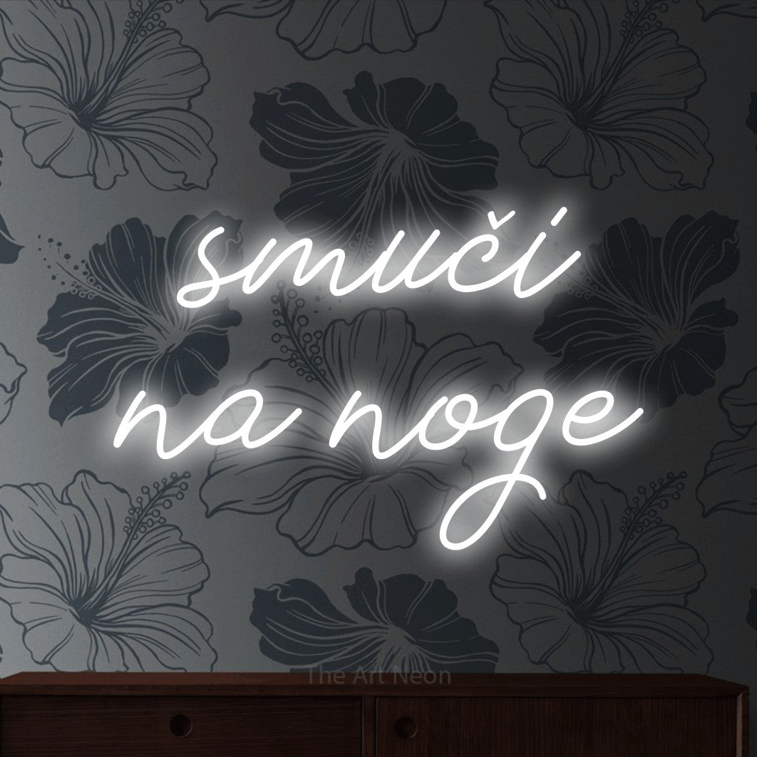 LED neon sign reading “smuči na noge”, arranged in two lines.
