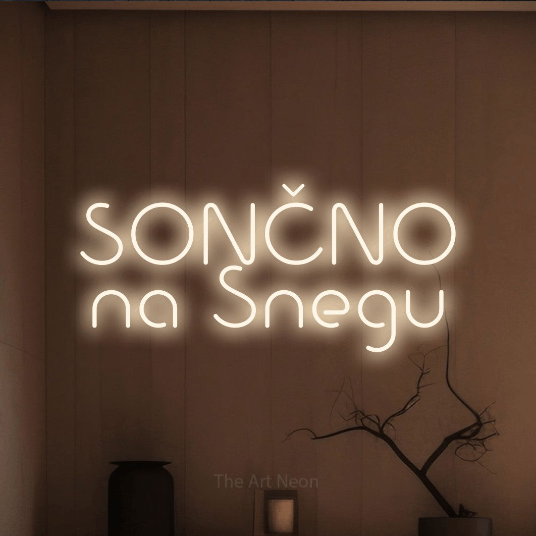 LED neon sign reading “SONČNO na Snegu”, arranged in two lines.