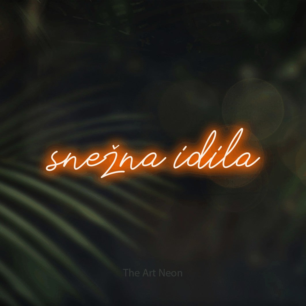 LED neon sign reading “snežna idila”, arranged in a single line.